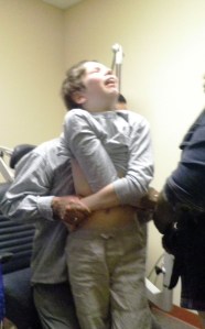 You can see one caregiver behind him and one in front.