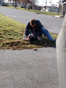 Jonah's daddy, holding him on the grass of the Anderson School campus during a recent aggression. Jonah's got his shirt tight in one hand. Eventually, Jonah calmed down. Once under control, Jonah got into the car and we started our visit.